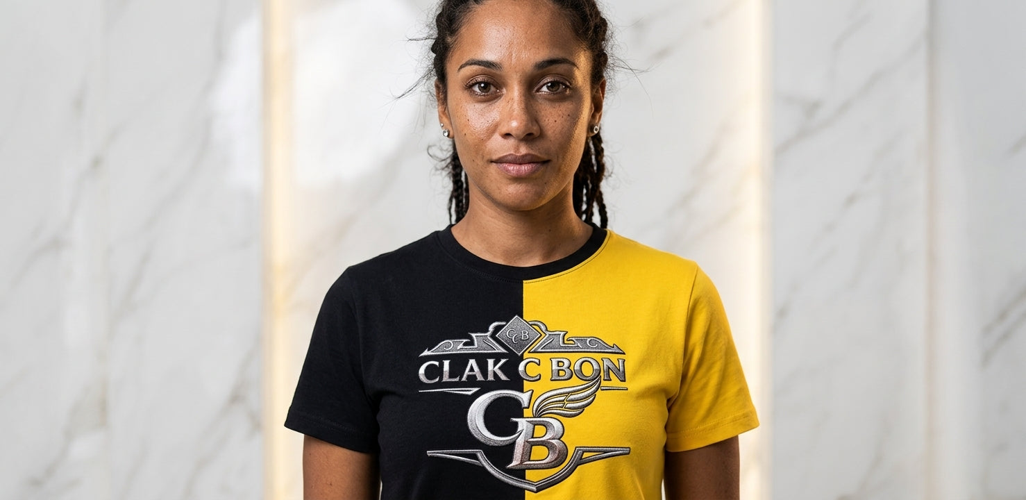 Une femme aux longs cheveux tressés pose devant un mur de marbre, portant le Polo Élégant Clak Cbon - Haute Couture Exclusif de Clak Cbon avec le lettrage CLAK CBON et un emblème ailé, rayonnant d'un luxe moderne.